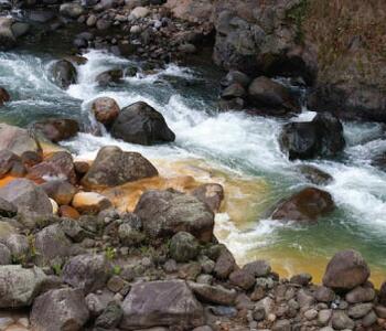 a river in Costa Rica tinted yellow by sulfur