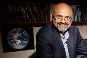 Atul Jain in front of the picture of the earth